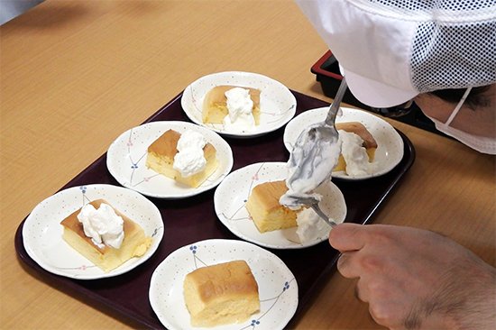 スフレケーキは高齢者の方が食べやすいように、生地に入る卵白を通常よりも多く泡立て、口当たりやのど越しを一層滑らかにしています。生クリームを添えて提供しました