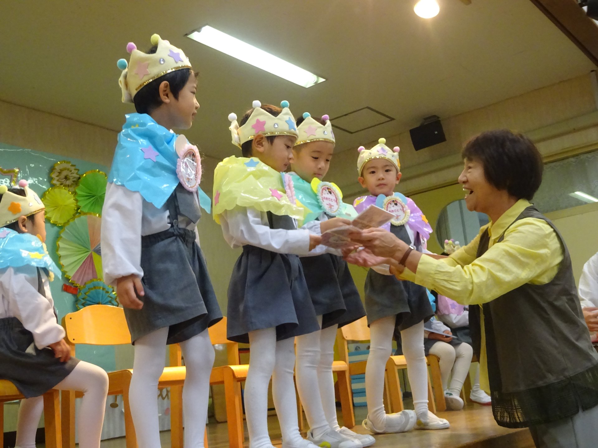 園長先生から誕生カードを受け取る子どもたち